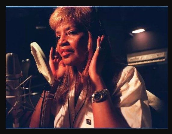 Sylvia Moy listening with headphones